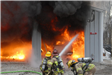 Fire Trainees Extinguishing a Garage Fire