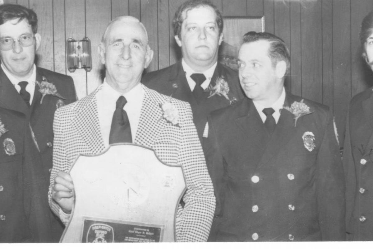 Black and White Photo of a Fire Employee Receiving an Award 1