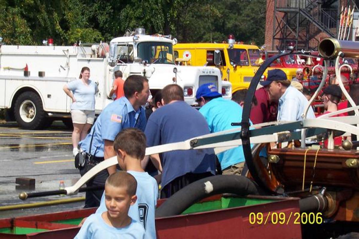 Firefighter Showing the Crowd a Fire Cart