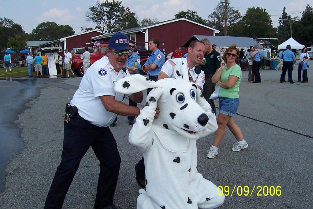Fire Dalmatian Mascot Character with Firefighters